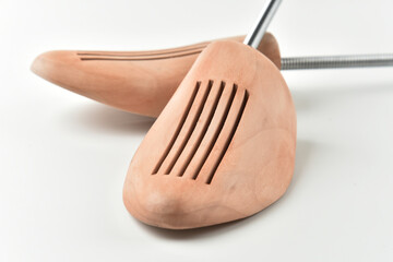 Wooden shoe lasts on a white background. Selective focus. Close-up.