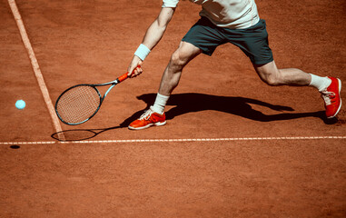 Male tennis player in action on the court on a sunny day