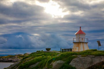 Fototapeta na wymiar small lighthouse in a wild and barren coastal landscape