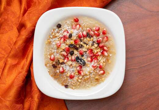 Traditional Turkish Dessert is Asure "Noah's Pudding" on wooden background