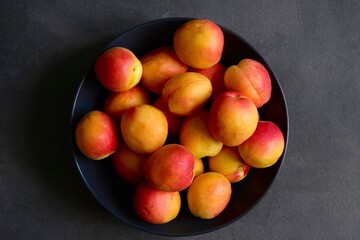 Delicious, colorful, delicious apricots on a dark background. The view from the top.