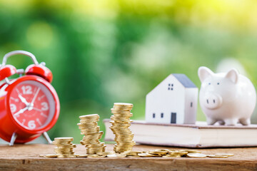 Stack gold coin with benefit from dividend and growth of value and house and alarm clock and piggy...