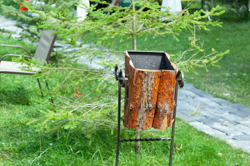One brown old rusty iron urn stands in the park.