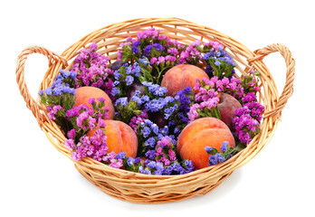 Fototapeta na wymiar Basket with peaches and statice.