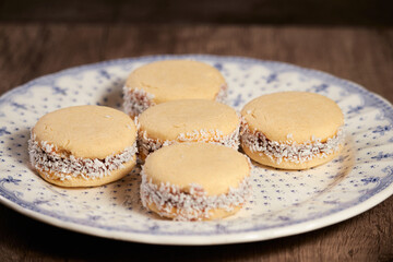 Delicious Argentinian cookies cornflow alfajores with cream dulce de leche close-up isolated. White vanilla macaroons on white background. French delicate dessert for Breakfast.