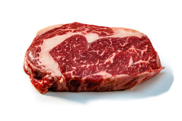 Ribeye. A raw marbled beef steak sits on a white background with a shadow.