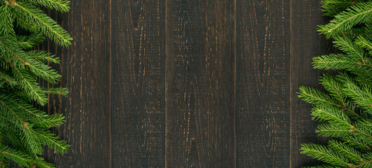 Christmas background with fir branches on wooden backdrop