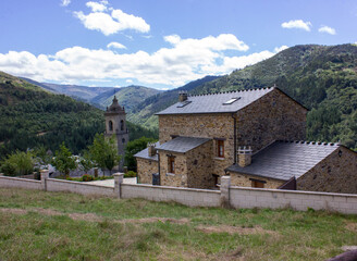 image of the parish church san martin de los oscos with a background of mountains and clouds