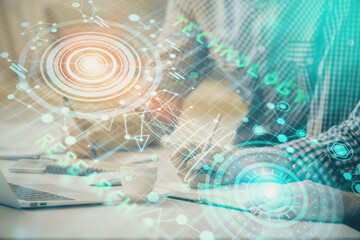 Businessman with computer background with technology theme hologram. Concept of hightech. Multi exposure.