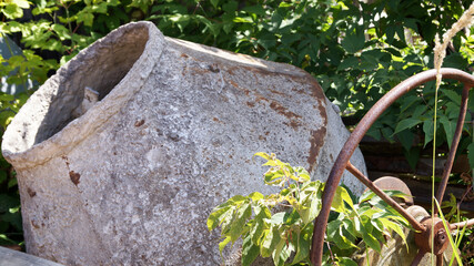 old rusty concrete mixer in the grass close up