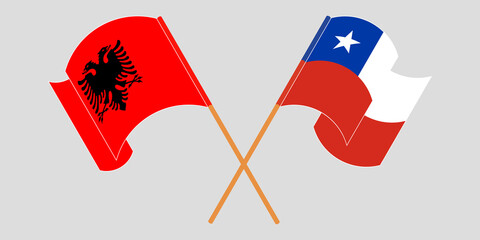 Crossed and waving flags of Albania and Chile