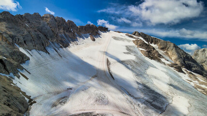 Aerial view of Marmolada Glacier from drone in summer season, Dolomite Mountains
