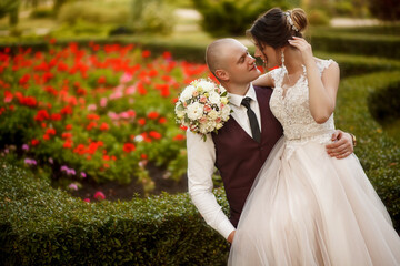 Portrait of a happy wedding couple on their wedding day,beautifully dressed newlyweds tenderly hug...