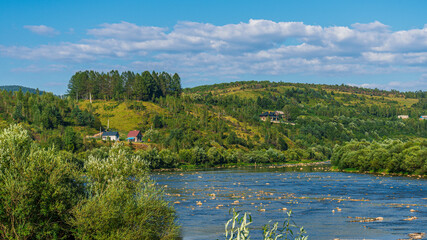 Fototapeta premium Summer landscape in the Carpathian mountains, the Stryi river in Rybnyk village. 