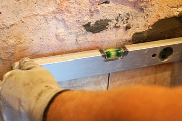 checking the level of ceramic tiles close up
