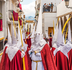 People participating in the Holy Week procession in a Spanish city during Easter