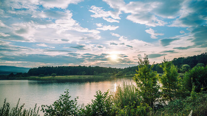 Obraz na płótnie Canvas Sunset at the lake in mountains. Dobrohostiv village.