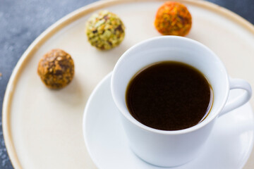 Coffee espresso and truffles balls on the plate