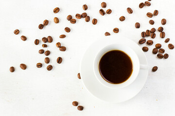 Coffee espresso in the cup on the white background and coffee beans, black coffee
