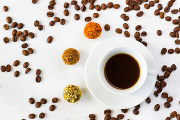 Coffee espresso and truffles balls on the plate