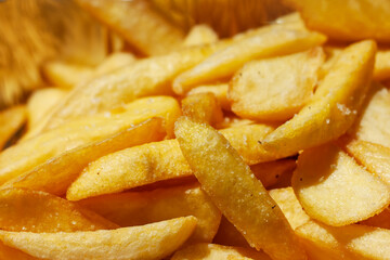 French fries background. Yummy potato fry close up. Fast food o street food concept.