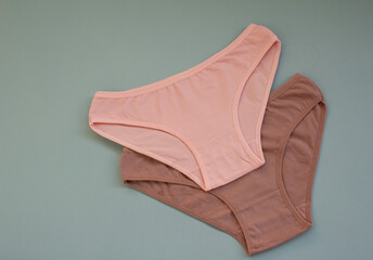 Women's underwear made of cotton fabric on a gray background. Women's underwear. Two women's...