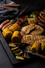 Grilled sausages, meat, and vegetables.