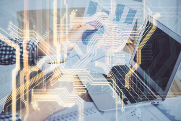 Technology theme hologram with man working on computer on background. High tech concept. Multi exposure.