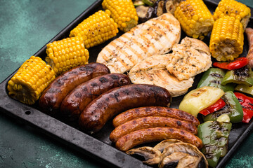 Grilled sausages, meat, and vegetables.