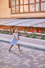 Little girl of 3 years runs near the run