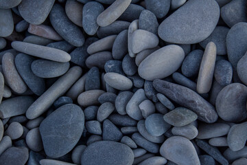 sea stones or pebbles on the seashore, at sunset on a sunny day. shooting a little slow, you can see the beautiful colors of the stones