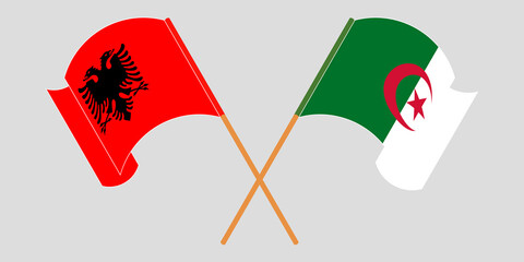 Crossed and waving flags of Albania and Algeria