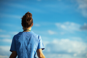 modern medical practitioner woman outdoors in city against sky