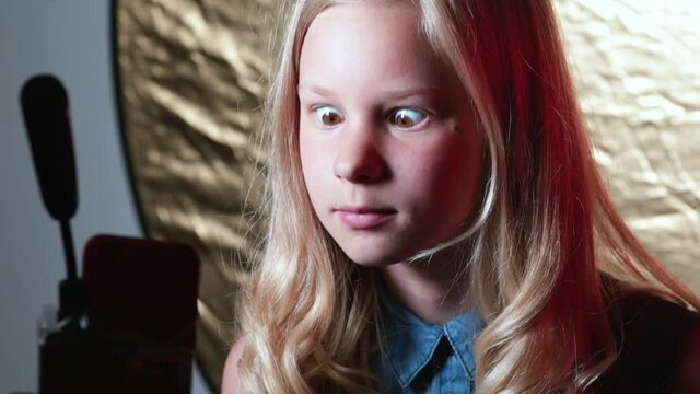 Teenage girl moves her eyes to the side. Blog video recording of funny moments of life. Grimacing and grimacing, the motivation of a positive life.