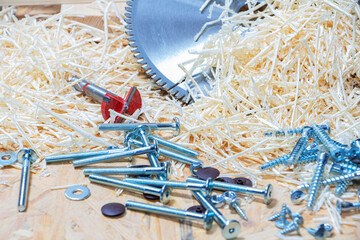 Carpenter tools on wooden table with sawdust. Circular Saw. Carpenter workplace top view.