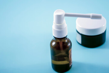 medical glass bottle with sprayer on top near glass bottles