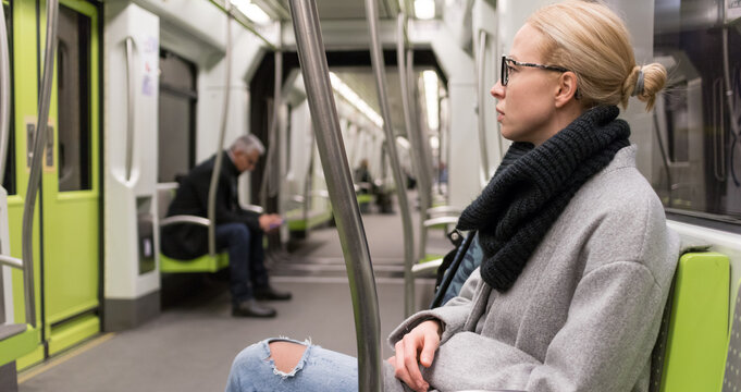 Portrait of lovely girl commuting on almost empty public subway train. Staying at home and social distancing recomented due to corona virus pandemic outbreak. - Powered by Adobe
