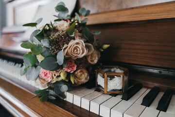 Bridal bouquet of white flowers lay on the piano