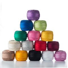 pyramid of multicolored balls of thread isolated on white