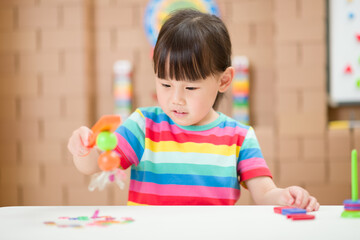 young  girl  play magical magnet experiments at home for homeschooling