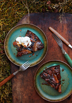 Rum spiced pecan and pear chocolate upside down cake slice with whipped cream