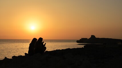 Fototapeta na wymiar Sunrise over Xwejni Saltpans in Gozo (Island of Malta)