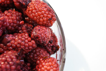 Bowl of blackberries on a white background