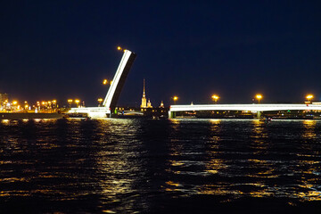 Fototapeta na wymiar Open bridge in Saint Petersburg, Russia. Liteiny bridge at night. Divorced Liteiny Bridge, Peter and Paul Cathedral