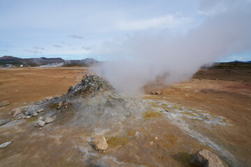 Hverir geothermal area in the north of Iceland near Lake Myvatn, with geothermal lake, looking like Blue Lagoon, Hot Mud Pots and great landscape in the Geothermal Area Hverir, summer day.