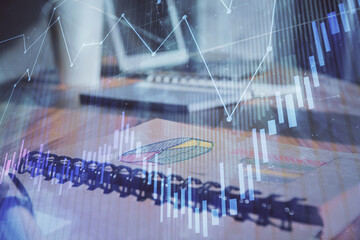 Fototapeta na wymiar Double exposure of financial graph drawings and desk with open notebook background. Concept of forex market