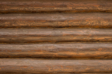 Horizontal parallel wooden logs background. Wall of pine logs in natural color with wood texture, decorated with a rope.