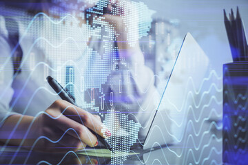 Double exposure of woman hands typing on computer and financial graph hologram drawing. Stock market analysis concept.