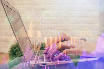 Multi exposure of woman hands typing on computer and forex chart hologram drawing. Stock market analysis concept.