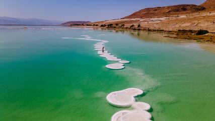 Aerial footage of Round shaped Salt deposits in the heart of the Dead Sea - obrazy, fototapety, plakaty